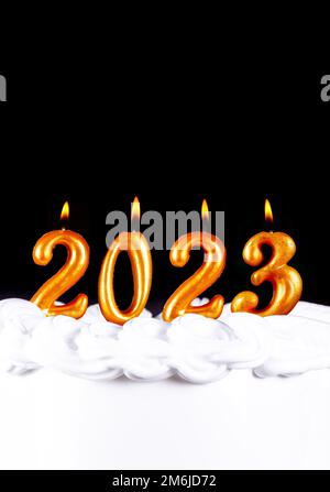 Golden candles write numbers flame Happy new year 2023 Stock Photo