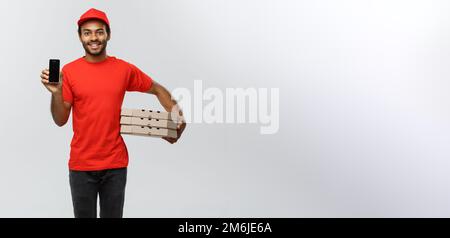 Delivery Concept - Portrait of Handsome African American delivery man or courier with pizza box showing mobile phone on you to c Stock Photo