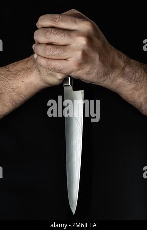 Person hairy skin chef holding kitchen knife by two hands Stock Photo