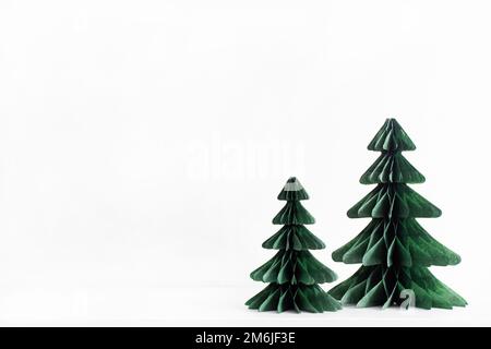 Trendy decorative Christmas trees, which made of paper with blurred house background, DIY project, Organic Modern Design, Hangin Stock Photo