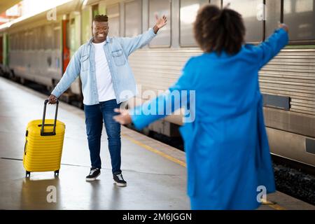 Black Couple Meeting On Platform At Railway Station After Train Arrival Stock Photo