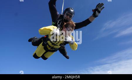 Sgt. 1st Class Ryan Reis of the U.S. Army Parachute Team takes former Pfc. Jessica Lynch on a tandem skydive at Laurinburg- Maxton Airport on 28 April 2022.  Lynch, a former POW, participated in the skydiving event to raise awareness for mental health challenges that female veterans face. Stock Photo