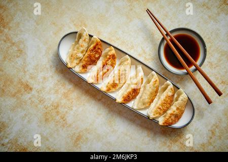 Orginal asian dumplings gyoza served in long plate Stock Photo
