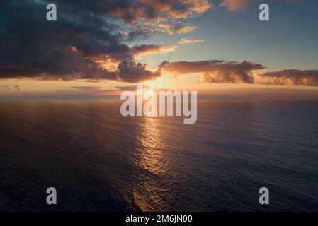 Sunset in dramatic clouds over sea Stock Photo