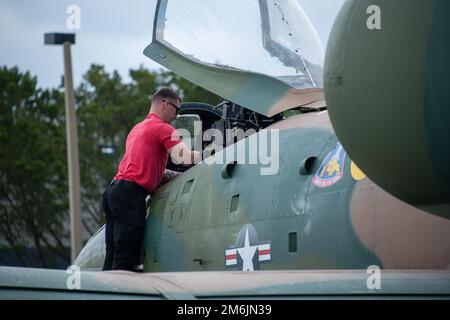 U.S. Air Force Staff Sgt. Robby Benson, A-10C Thunderbolt II Demonstration Team electrical and environmental technician, performs post-flight inspections on an A-10 Thunderbolt II in Fort Lauderdale, Florida, April 28, 2022. The A-10 Demonstration Team is made up of 11 personnel, including a pilot, nine maintenance personnel and a public affairs specialist. The mission of the A-10 Demonstration Team is to recruit, retain and inspire. A10DemoTeam,Air Combat Command,AirPower,United States Air Force,airmen,airshow, Stock Photo