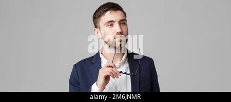 Business Concept - Portrait of a handsome businessman in suit with glasses serious thinking with stressful facial expression. Is Stock Photo