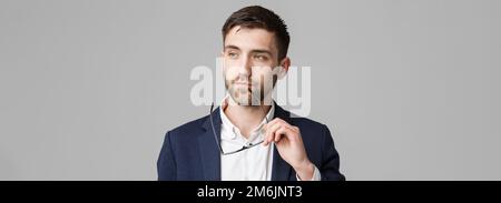 Business Concept - Portrait of a handsome businessman in suit with glasses serious thinking with stressful facial expression. Is Stock Photo
