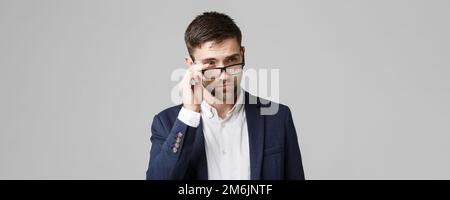 Business Concept - Portrait of a handsome businessman in suit with glasses serious thinking with stressful facial expression. Is Stock Photo
