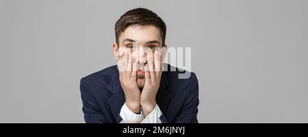 Business Concept - Portrait handsome handsome business man in suit smiling and siting in work office with serious and depressed Stock Photo