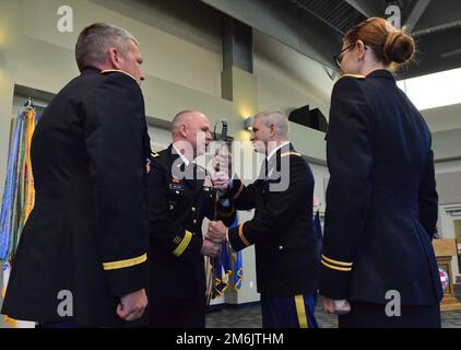 Georgia Army National Guard Commander, Brigadier General Dwayne Wilson passes the ceremonial sword to incoming Command Chief Warrant Officer of the Ga. ARNG, CW5 Mark Joiner during a change of responsibility ceremony April 29, 2022, at the Clay National Guard Center in Marietta, Ga. Stock Photo