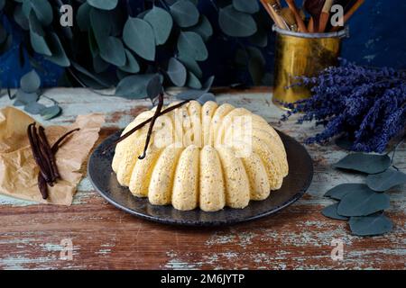 Traditional Italian steamed egg milk cream vanilla pudding in bundt cake shape served as close-up on a Nordic design plate with Stock Photo