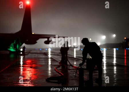 USCENTCOM, Undisclosed Location. 23rd Dec, 2022. Senior Airmen Zackary Short and Keven Torres, forward area refueling point (FARP) specialists assigned to the 26th Expeditionary Rescue Squadron, prepare to provide fuel to a U-28 Draco from a HC-130J Combat King II, enabling a rapid turnaround and launch at an undisclosed location within the U.S. Central Command area of responsibility, December. 23, 2022. FARP specialists provide a unique refueling capability, extending the reach and effectiveness for a variety of aircraft, while reducing turnaround times in austere locations across the CE Stock Photo