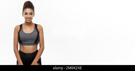 Healthy and Fitness concept - Beautiful American African lady in fitness clothes ready for workout. Isolated on white background Stock Photo