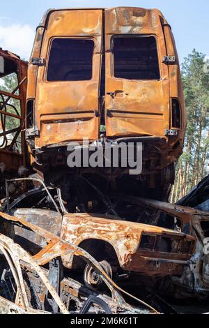 A lot of rusty burnt cars in Irpen, after being shot by the Russian military. Russia's war against Ukraine. Cemetery of destroye Stock Photo