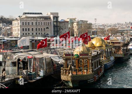 Turkish national flags with white star and moon in sky on boat Stock Photo