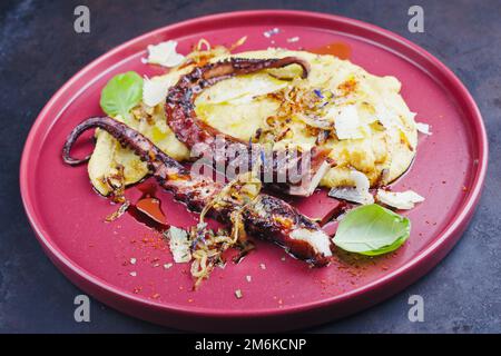 Traditional Italian polpo alla griglia su crema di polenta with grilled octopus Stock Photo