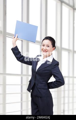 Young business lady holding a folder Stock Photo