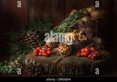Kernel walnuts and other fruits on dark wooden background Stock Photo
