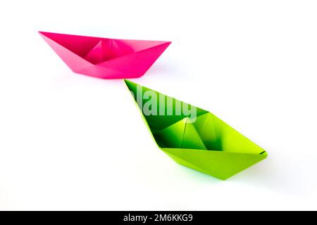 Pink and green paper boat origami isolated on a white background Stock Photo