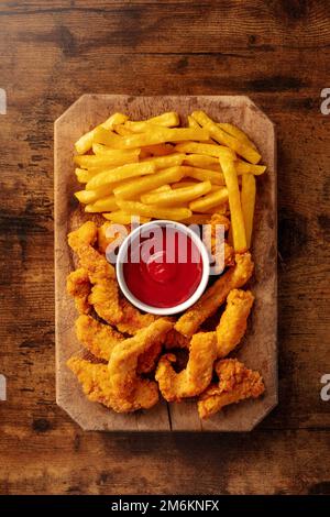 Chicken tenders, battered and fried crispy wedges, with a bbq sauce Stock Photo