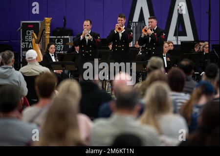 ANN ARBOR, Mich. (April 30, 2022) Musician 1st Class Chuck Bindis, left, from Cleveland, Musician 1st Class Peter Pirotte, center, from Raleigh, N.C., and Musician 1st Class Ethan Bartley, from Kansas City, Mo., perform with the United States Navy Band at Pioneer High School in Ann Arbor, Michigan. The U.S. Navy Band performed in five states as part of a national tour, connecting communities with their Navy. Stock Photo