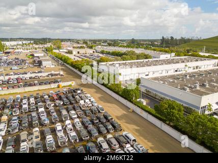 Aerial photo of a car junk yard next to warehouses Stock Photo