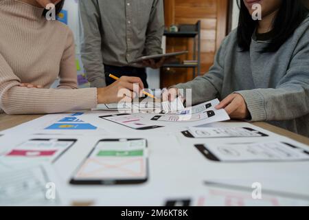 Young Asian Start up new business working at creative office. Modern start-up business team. Co-workers ui, ux startup small business Stock Photo