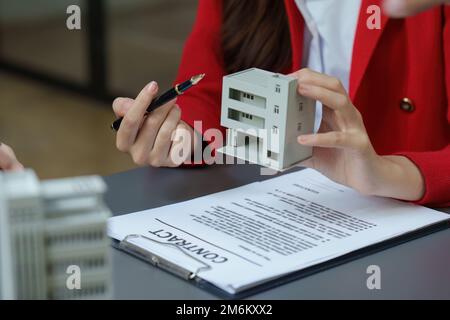 Real Estate Agent explain insurance and agreement contract to client before sign contract. Property insurance and security concept Stock Photo