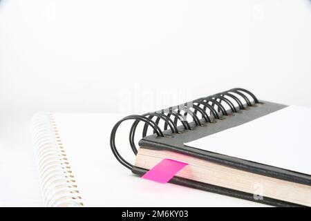 Blank Opened Spiral Notebook Placed On A Table. Empty Open Notepad On Top Of A Desk Stock Photo