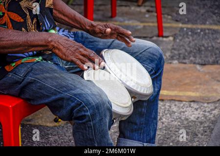 Percussionist playing bongo in street Stock Photo