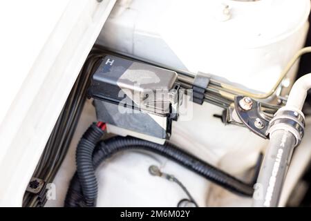 Electric fuse box in car engine bay Stock Photo