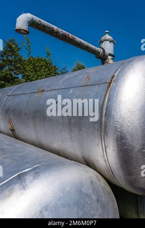Vertical shot of rusty metal cisterns Stock Photo