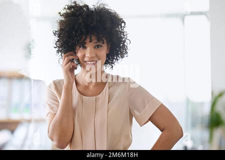 Another happy client on the line. a beautiful young businesswoman talking on her cellphone in the office. Stock Photo