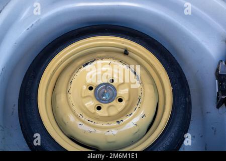 Stepney or donut tyre in a car boot space for temporary use Stock Photo