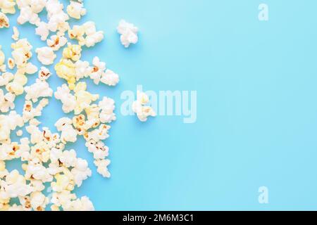 Scattered popcorn on color background Stock Photo