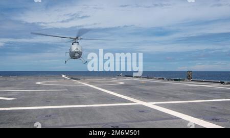 220429-N-JX182-1063 SOUTH CHINA SEA (April 29, 2022) An MQ-8C Fire Scout, attached to the “Wildcards” of Helicopter Sea Combat (HSC) Squadron 23, assigned to the Independence-variant littoral combat ship USS Jackson (LCS 6) takes off. Jackson, part of Destroyer Squadron (DESRON) 7, is on a rotational deployment, operating in the U.S. 7th Fleet area of operations to enhance interoperability with partners and serve as a ready-response force in support of a free and open Indo-Pacific region. Stock Photo