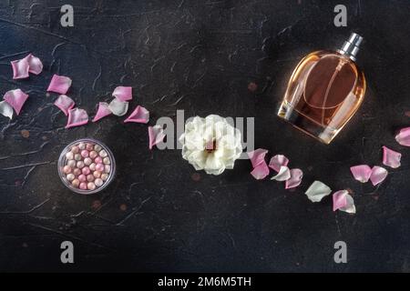 Beauty and cosmetics concept. A bottle of perfume and makeup, overhead Stock Photo