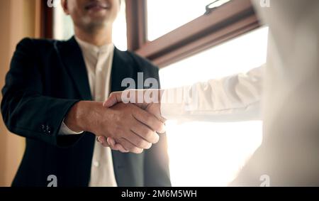 Close-up of two business people shaking hands. Stock Photo