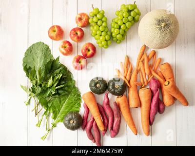 Various vegetables and fruits on wooden background Stock Photo