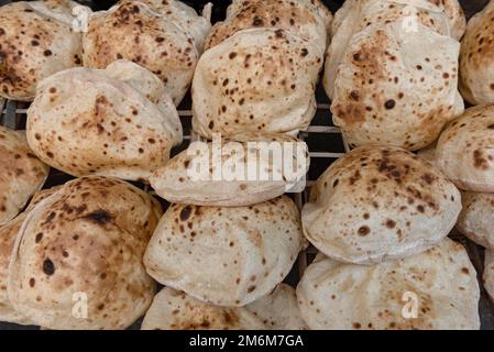 Freshly oven baked traditional Baladi flat bread, similar to pitta bread is a staple of Egyptian cuisine is cooked all over Egypt Stock Photo