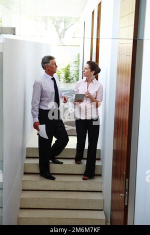 I am able to store all my documents on this digital tablet. Two business people discussing the technological future of the company. Stock Photo