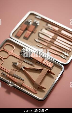 Pastel cosmetic set for nail care in a case placed on a pink background Stock Photo