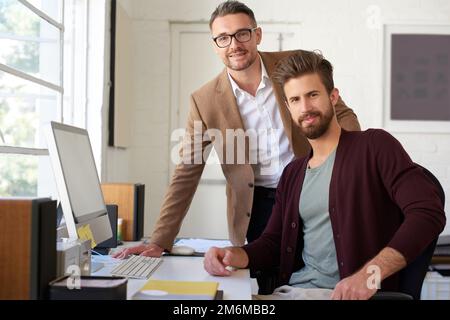 Lets talk creative planning. Portrait of two male designers looking seriously at the camera. Stock Photo