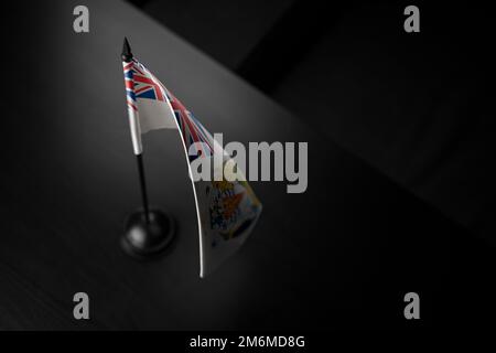 Small national flag of the British Antarctic Territory on a black background. Stock Photo