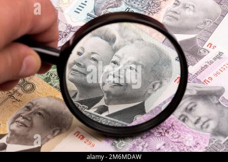 Cambodian riel in a magnifying glass a business background Stock Photo