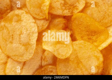 Potato chips texture, a salty snack, a pile of yellow crisps Stock Photo