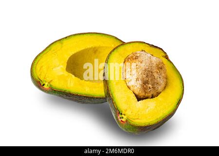 Half ripe avocado fruit with seed isolated on white background. Stock Photo