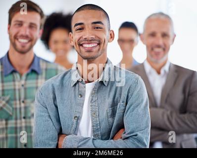 Hes going places. Handsome young businessman with a diverse range of people in the background. Stock Photo