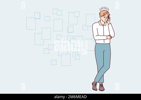 Young creative man project manager stands cross-legged and touches head thinking about future development of company. Startup employee guy posing near wall with stickers. Flat vector illustration Stock Vector