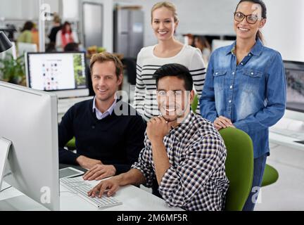 Portrait of a positive team. Group of coworkers smiling at the camera in an office space. Stock Photo